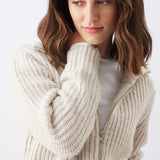 Chunky Zip Knit Maternity Cardigan (Oat) | Ripe Maternity Woman wearing a beige ribbed knit cardigan on a white background