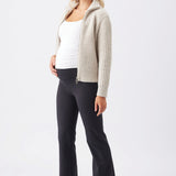 Chunky Zip Knit Maternity Cardigan (Oat) | Ripe Maternity Woman wearing a beige cardigan, white top, and black pants on a white background